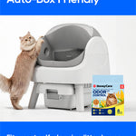 A cat stands on its hind legs beside a white and gray self-cleaning litter box. The image includes marketing text reading 'Auto-Box Friendly' and 'Fits most self-cleaning litter boxes,' plus a HoneyCare OdorControl litter box package shown on the right.